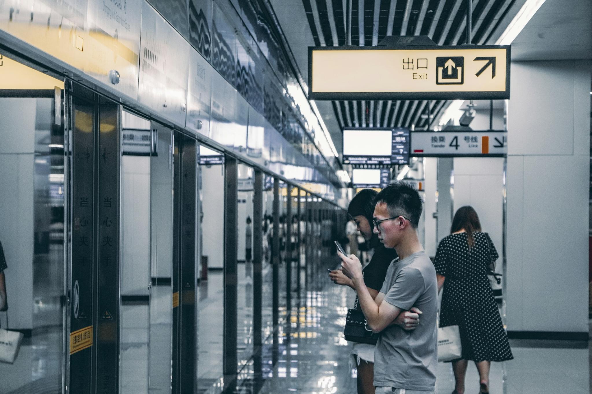 People looking at their phone on the subway in China